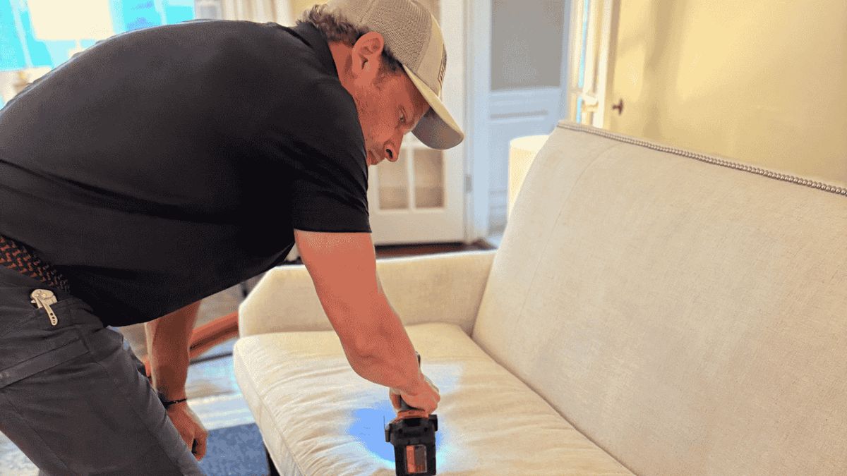 Louisville Flood Restoration technician cleaning upholstery in a Louisville home